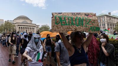 Student protesters march round their encampment at Columbia University. AP