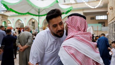 Sunni worshippers exchange greetings after Eid al-Fitr prayers to mark the end of the fasting month of Ramadan in Mosul, Iraq. Reuters