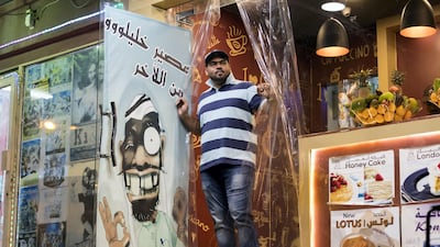 Shahnawaz Shaikh stands outside the Teapot cafe, one of the many karak shops that have opened in the fish market area in Ras Al Khaimah. Chris Whiteoak / The National