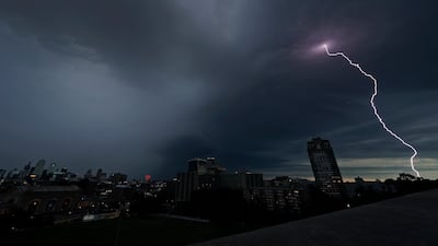 Lightning strikes in the distance as a thunderstorm passes over downtown Kansas City, Missouri. AP