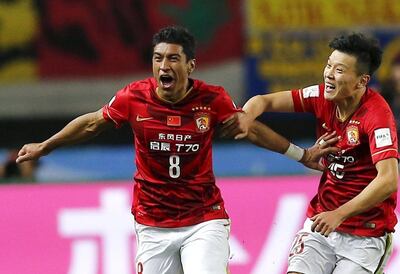 Guangzhou Evergrande midfielder Paulinho, left, celebrates his winner against Mexican club America in the Club World Cup in Osaka, Japan. Thomas Peter / Reuters