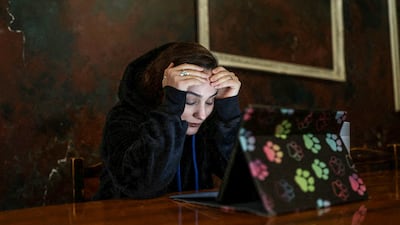An Iranian woman reacts as she struggles to access the internet amid nationwide disruptions. Reuters
