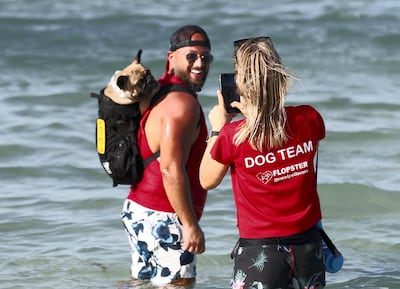 Guest Ziad with his pet dog Potato attend the first dog-friendly Flopster Beach Day in Ghantoot, Dubai, on Friday, October 16, 2020. Chris Whiteoak / The National