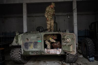 Ukrainian servicemen inspect a Russian MT-LB in the Kharkiv area, eastern Ukraine, Sunday, May 29, 2022. The Ukrainian military has been recovering abandoned Russian combat vehicles on the frontline to repair them and use them to their advantage. (AP Photo / Bernat Armangue)