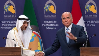 Iraqi Foreign Minister Fuad Hussein, right, greets Jassim Al Budaiwi, Gulf Co-operation Council Secretary-General, in Baghdad on Monday. AP