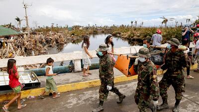 Philippines soldiers carry a body collected from the rubble in the devastated town of Tanauan on Saturday in Leyte, Philippines. Dan Kitwood / Getty Images