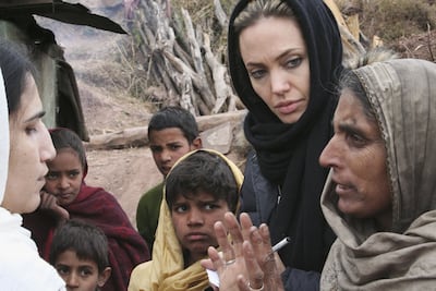 Angelina Jolie with villagers displaced by an earthquake in Pakistan in 2005. Getty Images