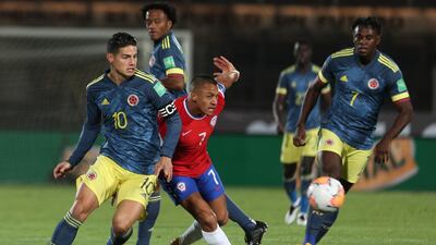 James Rodriguez and Alexis Sanchez battle for the ball. AP