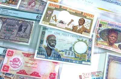 Early issues from South Asia and Africa, including a 1948 Reserve Bank of India 10-rupee note with Pakistan overprint and a Central African Empire 10,000-franc note. Victor Besa / The National
