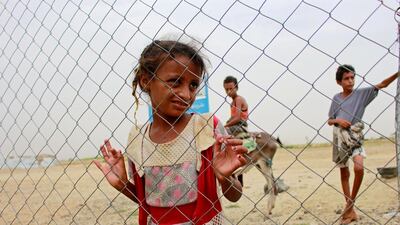 A girl looks through the fence of a closed clinic at a camp for internally displaced people near Abs of Hajjah province, Yemen, on August 19, 2020. Reuters