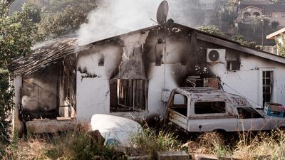 A picture taken on July 16, 2021 shows a house destroyed after angry mobs set fire to homes in Duffs Road near Phoenix, where racial tensions have also been reported as President Cyril Ramaphosa visits the Kwazulu-Natal province where violence continued for 6 days. - South African President Cyril Ramaphosa on Friday alleged that deadly violence and looting that have shaken the country over the past week were planned. "It is quite clear that all these incidents of unrest and looting were instigated -- there were people who planned it and coordinated it," Ramaphosa said in a visit to KwaZulu-Natal (KZN) province, the flarepoint for post-apartheid South Africa's worst crisis.