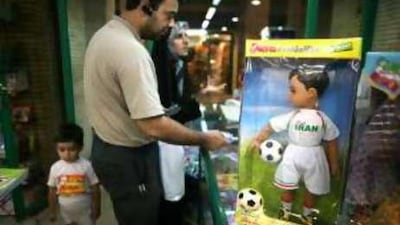 An Iranian family buy their son Dara and Sara National Iranian dolls.