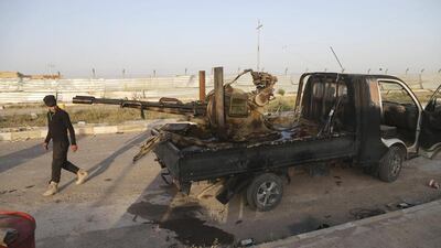 A member of an Iraqi Shiite militant group called Imam Ali Brigades patrols in Tikrit on March 25, 2015. Khalid Mohammed/AP Photo