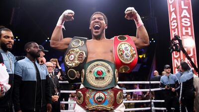 Anthony Joshua celebrates after reclaiming the IBF, WBA, WBO & IBO heavyweight championship belts from Andy Ruiz Jr in Saudi Arabia. PA Photo