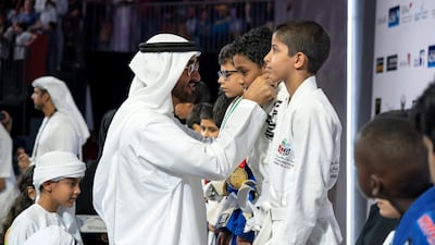 Sheikh Mohammed bin Zayed Al Nahyan Crown Prince of Abu Dhabi Deputy Supreme Commander of the UAE Armed Forces (L), awards a medal to a participant during the Abu Dhabi Jiu-Jitsu Festival. Mohamed Al Hammadi / Crown Prince Court - Abu Dhabi