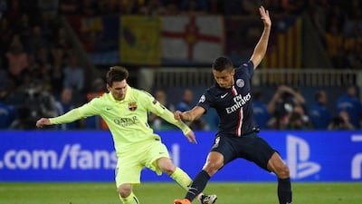 Barcelona's Lionel Messi and Paris Saint-Germain's Marquinhos battle for the ball on Wednesday during their Champions League contest. Martin Bureau / AFP