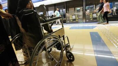 Moza Abdullah Senan waits in her wheelchair for the Metro train at Khalid bin Waleed station.