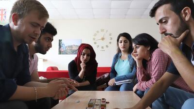 Iraqi artist Hoshmand Mofaq and British archaeologist Ashley Barlow, left, play an ancient board game, known as the Royal Game of Ur, in the northern Iraqi city of Raniey. Originating nearly 5,000 years ago in what would become Iraq, the Royal Game of Ur mysteriously died out -- until Muwafaq resurrected it by making his own decorated wooden board. AFP