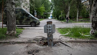 A military van drives past an unexploded missile in Lysychansk. Getty Images