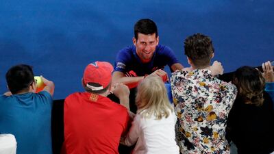 Serbia's Novak Djokovic signs autographs after defeating Daniil Medvedev of Russia in the fourth round in Melbourne. Aaron Favila / AP Photo