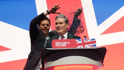 A protester throws glitter over Keir Starmer during his keynote speech at the Labour Party conference in Liverpool. PA