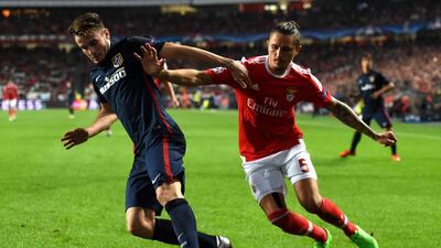 Midfielder Saul Niguez, left, and his Atletico Madrid teammates have quietly climbed to second in Primera Liga and top their Uefa Champions League group. Francisco Leong / AFP