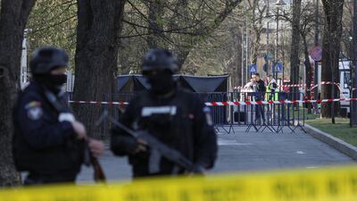 Police stand guard as crime scene investigators check the area. Reuters