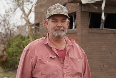 Wes Mills stands in front of his brother's destroyed orthodontists office in Mayfield, Kentucky. Willy Lowry / The National