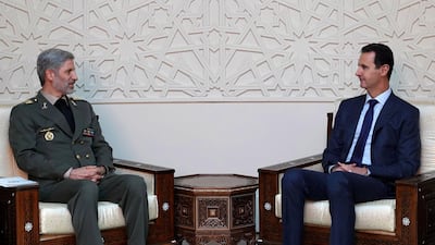 Iranian defence minister Amir Hatami, left, meets with Syrian president Bashar Al Assad in Damascus. SANA/AFP