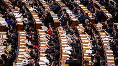 Delegates check their ballot tickets during the third plenary session of the 13th National People's Congress at the Great Hall of the People in Beijing, China. The NPC has over 3,000 delegates and is the world's largest parliament or legislative assembly. Roman Pilipey / EPA
