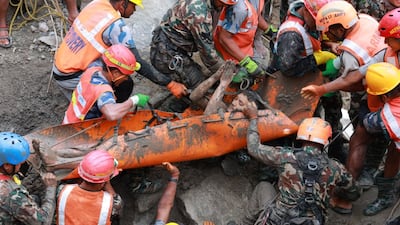 A survivor is rescued from a tunnel at a hydropower plant, after the devastating flash flood in Nepal. EPA