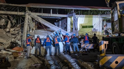 Rescuers search for survivors trapped in the debris. Getty