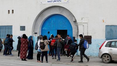 Parents and students are seen in front of a high school in Tunis, Tunisia. Reuters
