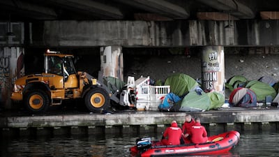 A makeshift camp is cleared away as French police evacuate hundreds of migrants living in tents along a canal in Paris, France. Benoit Tessier / Reuters