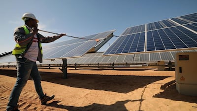 A man cleans solar panels at the Benban Solar Park in Aswan, Egypt. EPA