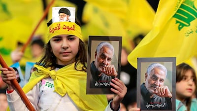 Supporters of Hezbollah hold photos of slain Iranian general Qassem Suleimani as they listen to a televised speech by Hezbollah leader Hassan Nasrallah in a southern suburb of the Lebanese capital Beirut. EPA