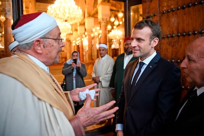 French President Emmanuel Macron speaks with a cleric as he visits the Zitouna mosque in the old town of Tunisian capital Tunis in 2018. AFP