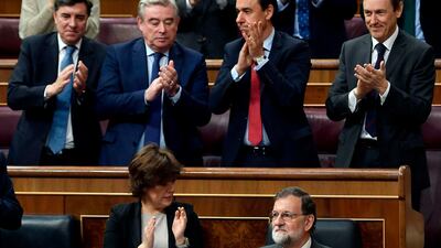 Members of the People's Party parliamentary group applaud Spanish Prime Minister Mariano Rajoy during a debate on a no-confidence motion tabled by socialist party in the lower house of the Spanish Parliament in Madrid on May 31, 2018. Oscar del Pozo / AFP
