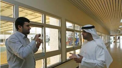 Hamad Al Darmaki, right, communicates with Abdullah Taljabini, his interpreter, through sign language at the National Association of the Deaf in Al Ain.