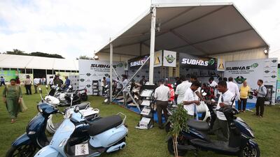Visitors inspect an exhibition stall during an electric vehicle expo in Bengaluru, India. Photo: EPA