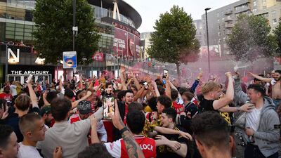 Arsenal fans celebrate outside the Emirates stadium. AFP