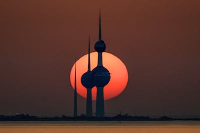 The sun sets behind the landmark Kuwait Towers in Kuwait City, where a gold-buying boom is taking place. AFP