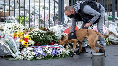 A police officer and sniffer dog checks flowers in front of the Notre Dame basilica in Nice, France. Getty