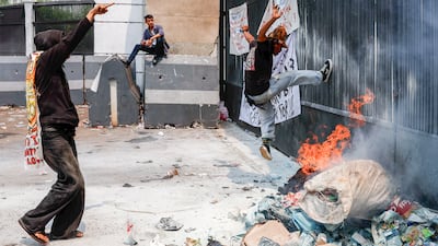 A protester kicks a gate during a demonstration against corruption outside the parliament building in Jakarta, Indonesia. EPA
