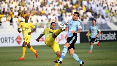 Baniyas striker Denis Stracqualursi, No 11, challenges an Al Wasl defender for the ball during their President's Cup round of 16 match at Baniyas Stadium in Abu Dhabi, on May 15, 2015. Lee Hoagland/The National
