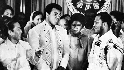 In this September 18, 1975, file photo, Philippines President Ferdinand Marcos, left, applauds as challenger Joe Frazier, right, makes some remarks about world champion Muhammad Ali, second from left, during their call on Marcos at the Malacanang Palace in Manila, Philippines. Jess Tan / AP photo