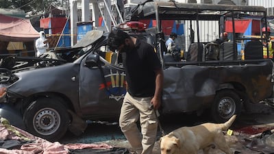 Officials examine the site of the bomb blast. AFP