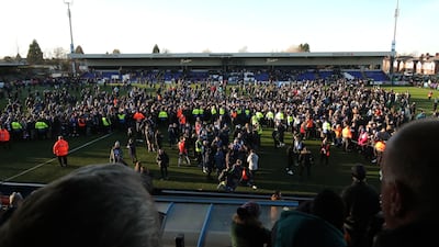 Macclesfield fans and players celebrate on the pitch after their 2-1 victory over Premier League Palace. Reuters