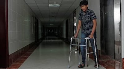 :Five months after having his right foot crushed after being run over by a school bus, Shahroz Khan, 14, still has to use a walking frame.
