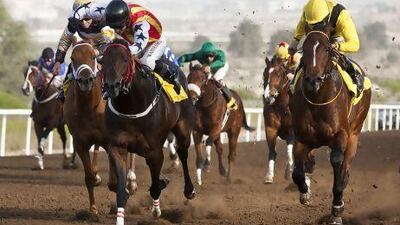 Jockey Wayne Smith, centre, rides Russian Rock to a win at Jebel Ali Racecourse. Antonie Robertson / The National